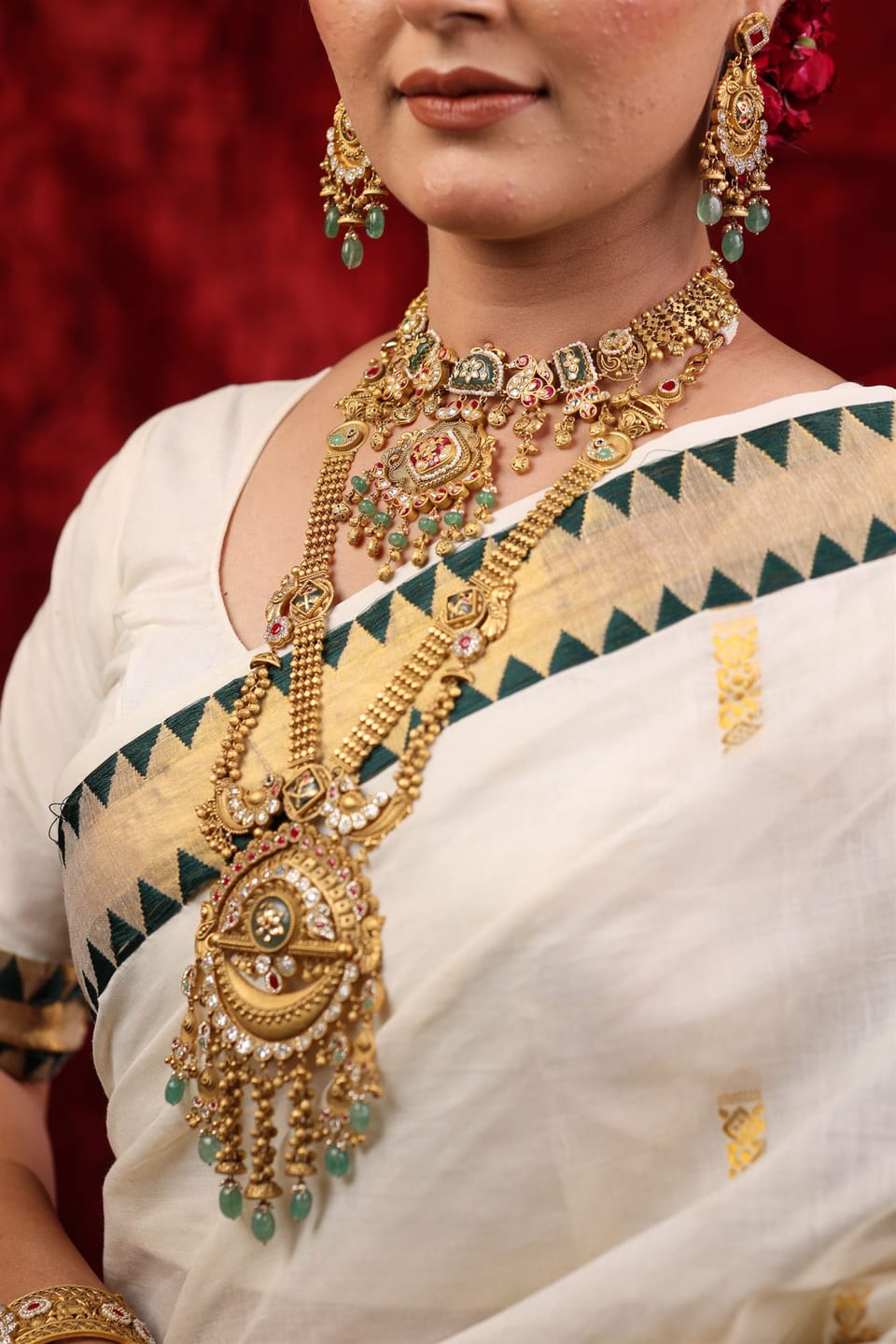 Layered gold temple chandan haar with emerald drops, worn by a Shree Jewels bride in Porbandar